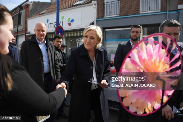 French presidential election candidate for the far-right Front National party Marine Le Pen , escorted by her bodyguard Thierry Legier tours the...