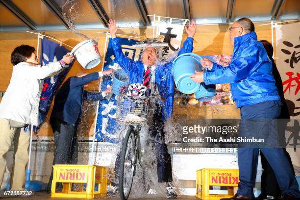Incumbent Nagoya City Mayor Takashi Kawamura is doused with warter to celebrate winning his fourth term at his election campaign headquarters on...