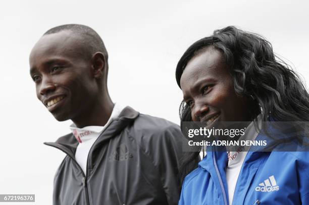 Kenya's Daniel Wanjiru and Mary Keitany pose during a photocall beside Tower Bridge, the day after winning the men's and women's elite races at the...