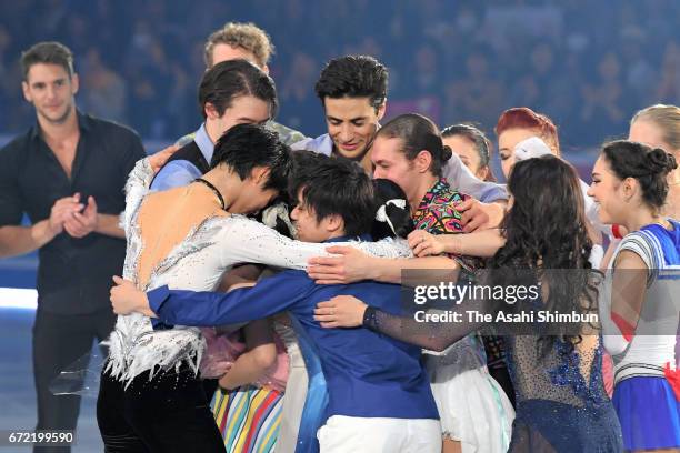 Kanako Murakami of Japan is embraced by skaters during her retirement ceremony at the gala exhibition during day four of the ISU World Team Trophy at...