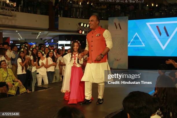 Amraah Sharma with Arjun Sharma, Director, Select Citywalk, walks the runway for the Vintage Affaire 3 Fashion Show at Select Citywalk on April 21,...