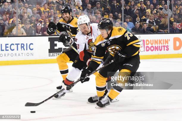 Mark Stone of the Ottawa Senators fights for the puck against Zdeno Chara and Charlie McAvoy of the Boston Bruins in Game Six of the Eastern...