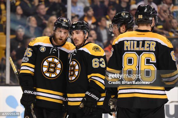 Joe Morrow and Brad Marchand of the Boston Bruins talk during a time out against the Ottawa Senators in Game Six of the Eastern Conference First...