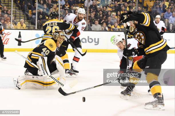 Tommy Wingels of the Ottawa Senators fights for the puck against Colin Miller and Tuukka Rask of the Boston Bruins in Game Six of the Eastern...