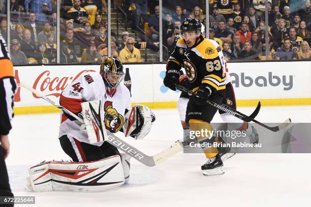 Craig Anderson of the Ottawa Senators catches the puck against Brad Marchand of the Boston Bruins in Game Six of the Eastern Conference First Round...