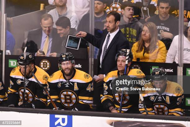 Assistant Coach Jay Pandolfo of the Boston Bruins uses an iPad during the game against the Ottawa Senators in Game Six of the Eastern Conference...