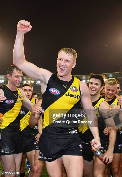 Josh Caddy of the Tigers high fives fans after winning the round five AFL match between the Richmond Tigers and the Melbourne Demons at Melbourne...