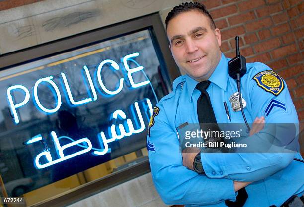 Dearborn Police Officer Cpl. Daniel Saab stands in front of the Community Policing Center mini-station November 19, 2001 in Dearborn, Michigan, where...