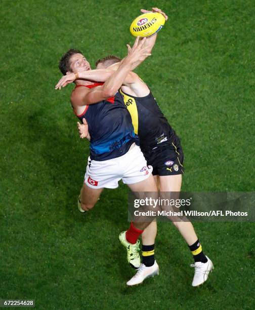 Jesse Hogan of the Demons and Josh Caddy of the Tigers compete for the ball during the 2017 AFL round 05 match between the Richmond Tigers and the...