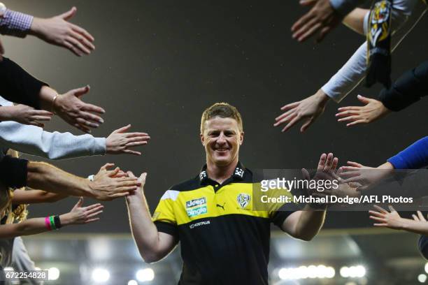 Tigers head coach Damien Hardwick celebrates the win with fans during the round five AFL match between the Richmond Tigers and the Melbourne Demons...