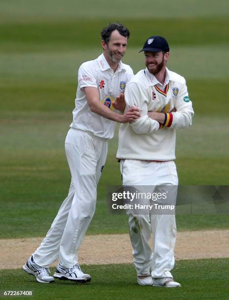 Graham Onions of Durham shares a joke with Ryan Pringle of Durham as they knock into each other during the Specsavers County Championship Division...