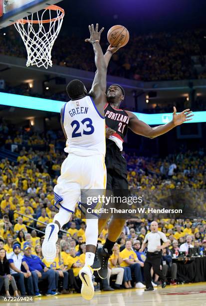 Draymond Green of the Golden State Warriors blocks the shot of Noah Vonleh of the Portland Trail Blazers in the third quarter during Game One of the...