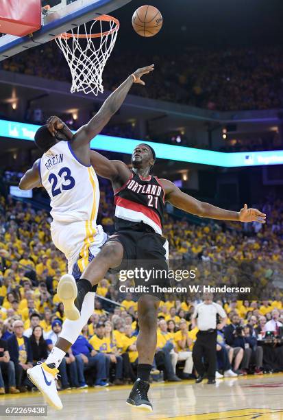 Draymond Green of the Golden State Warriors blocks the shot of Noah Vonleh of the Portland Trail Blazers in the third quarter during Game One of the...