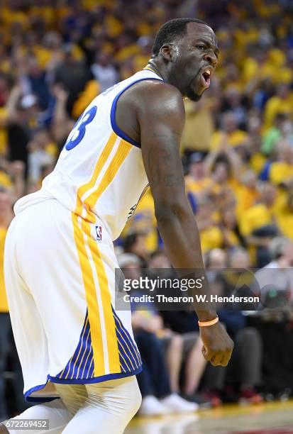 Draymond Green of the Golden State Warriors reacts after blocking the shot of Noah Vonleh of the Portland Trail Blazers in the third quarter during...