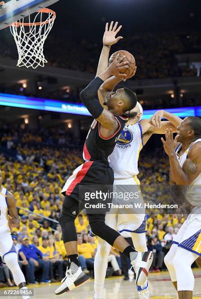 JaVale McGee of the Golden State Warriors blocks the shot of Damian Lillard of the Portland Trail Blazers in the third quarter during Game One of the...