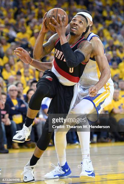 Damian Lillard of the Portland Trail Blazers drives to the basket for two point on JaVale McGee of the Golden State Warriors in the third quarter...