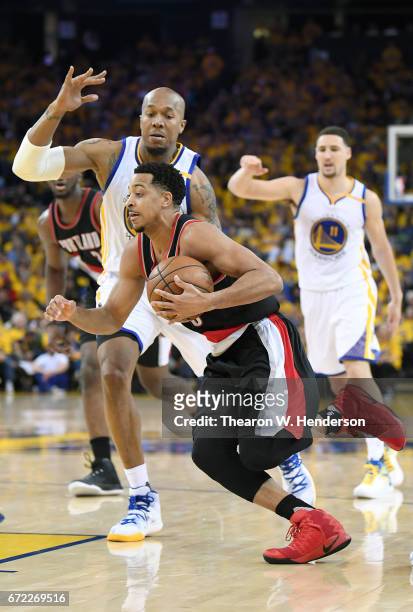 McCollum of the Portland Trail Blazers drives to the basket on David West of the Golden State Warriors in the fourth quarter during Game One of the...