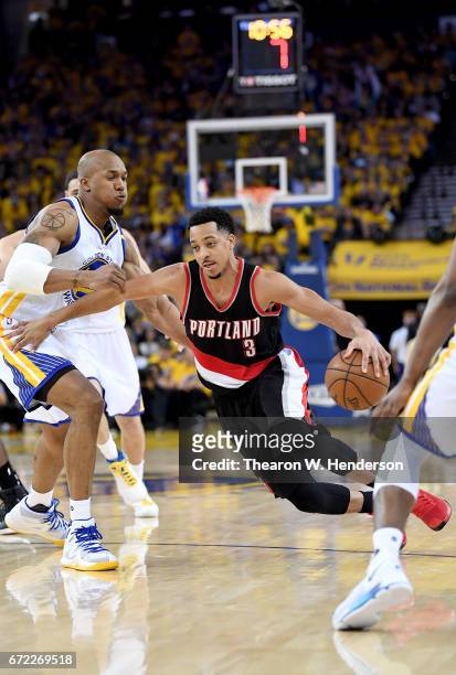McCollum of the Portland Trail Blazers drives to the basket on David West of the Golden State Warriors in the fourth quarter during Game One of the...
