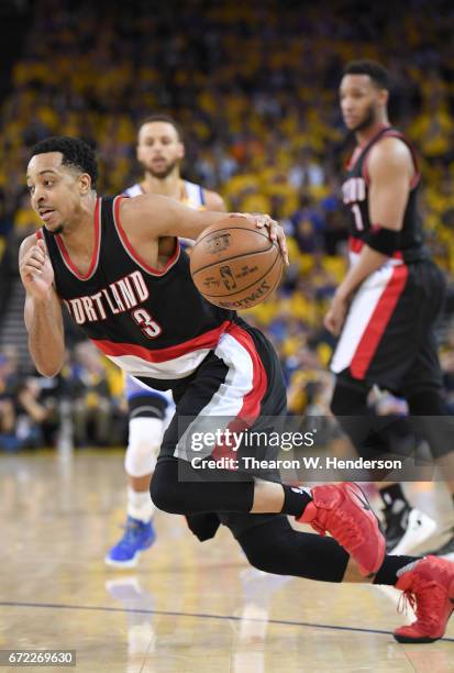 McCollum of the Portland Trail Blazers drives towards the basket against the Golden State Warriors in the fourth quarter during Game One of the first...