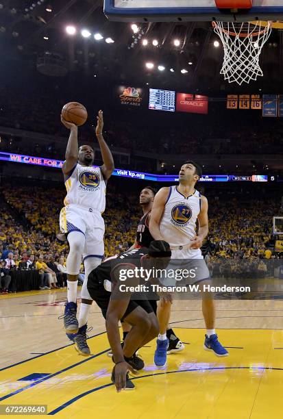 Kevin Durant of the Golden State Warriors shoots over Noah Vonleh of the Portland Trail Blazers in the first quarter during Game One of the first...