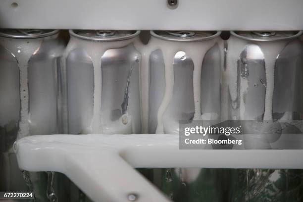 Beer cans are sealed by an Iron Heart Canning Co. Mobile canning machine at the Other Half Brewing Co. In the Gowanus neighborhood in the Brooklyn...