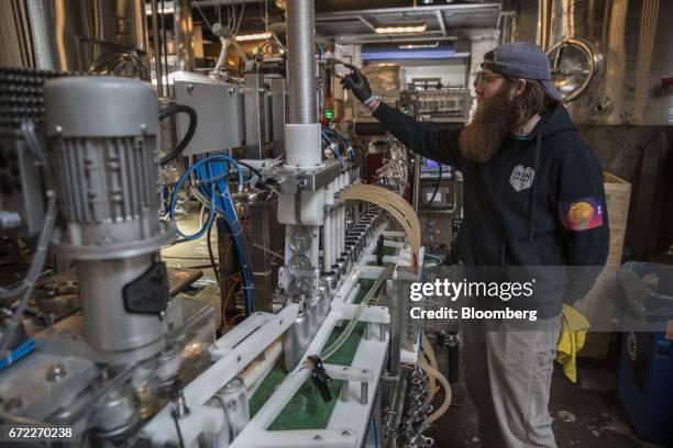An Iron Heart Canning Co. Employee operates a mobile canning machine at the Other Half Brewing Co. In the Gowanus neighborhood in the Brooklyn...
