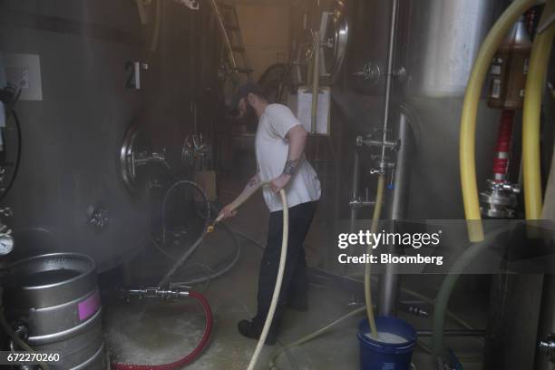 Worker cleans between tanks at the Other Half Brewing Co. In the Gowanus neighborhood in the Brooklyn borough of New York, U.S., on Tuesday, April...