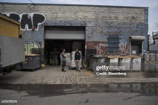Workers stands outside the Other Half Brewing Co. In the Gowanus neighborhood in the Brooklyn borough of New York, U.S., on Tuesday, April 18, 2017....