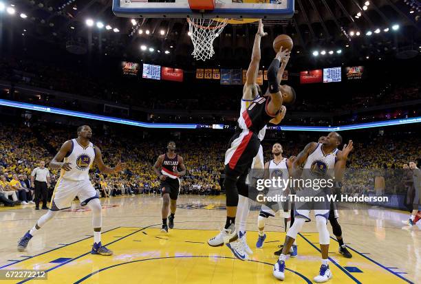 JaVale McGee of the Golden State Warriors blocks the shot of Damian Lillard of the Portland Trail Blazers in the third quarter during Game One of the...