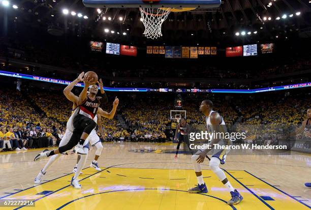 Damian Lillard of the Portland Trail Blazers drives to the basket for two point on JaVale McGee of the Golden State Warriors in the third quarter...