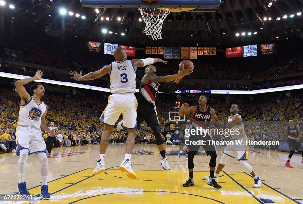 Damian Lillard of the Portland Trail Blazers drives to the basket for two point on David West of the Golden State Warriors in the third quarter...
