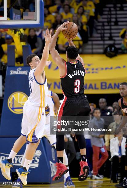 McCollum of the Portland Trail Blazers shoots over Klay Thompson of the Golden State Warriors in the second quarter during Game One of the first...
