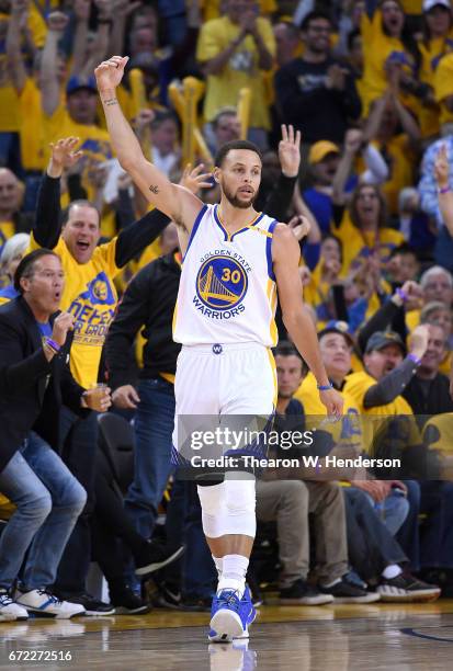 Stephen Curry of the Golden State Warriors reacts after making a three-point shot over Maurice Harkless of the Portland Trail Blazers in the third...