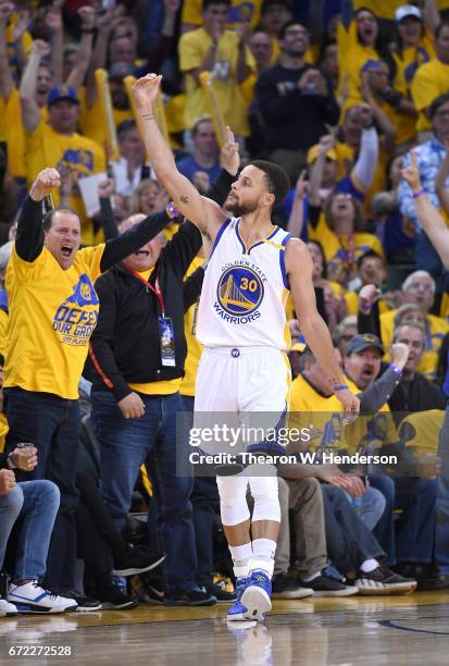 Stephen Curry of the Golden State Warriors reacts after making a three-point shot over Maurice Harkless of the Portland Trail Blazers in the third...