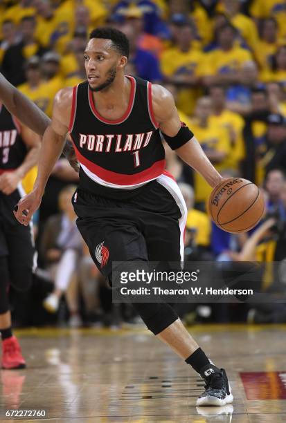 Evan Turner of the Portland Trail Blazers dribbles the ball up court against the Golden State Warriors in the third quarter during Game One of the...