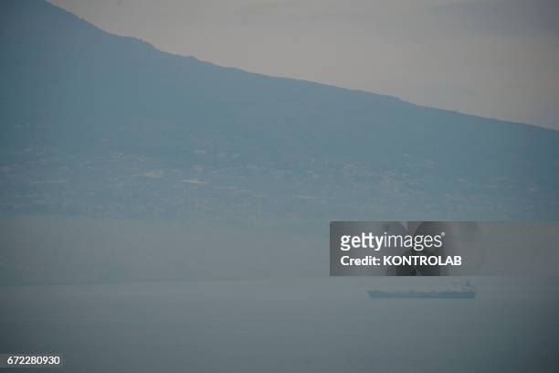 View of Naples covered with smog. Because of a particular climatic condition the city is covered by a cloud of smog. For days there is no wind and...
