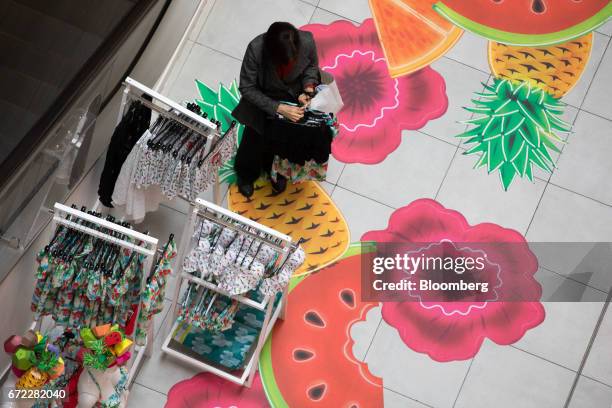 Shopper browses racks of clothing inside a Debenhams Ltd. Department store on Oxford Street in central London, U.K., on Monday, April 24, 2017....