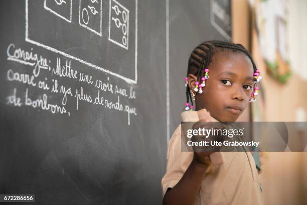 Dano, Burkina Faso An African schoolgirl is standing in front of a blackboard in a school of the Dreyer Foundation. Here children are cared for and...