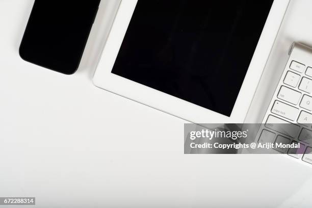 smartphone and tablet isolated on white background table with computer keyboard blank space - multimedia stock pictures, royalty-free photos & images