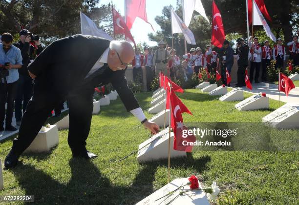 Turkish Culture and Tourism Minister Nabi Avci lays carnation on a Martyrs' cemetery during a ceremony marking the 102nd anniversary of the Canakkale...