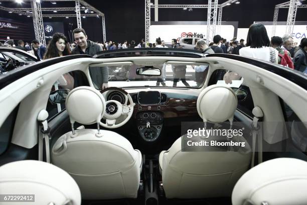 Visitors inspect a roofless Fiat 500 Riva automobile, manufactured in Turkey by Fiat Chrysler Automobiles NV, at the Istanbul Autoshow in...