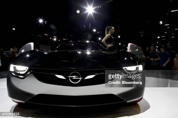 Model poses for visitors beside an Opel GT concept automobile, manufactured by Adam Opel AG, in Bykekmece, Turkey, on Sunday, April 23, 2017. The...