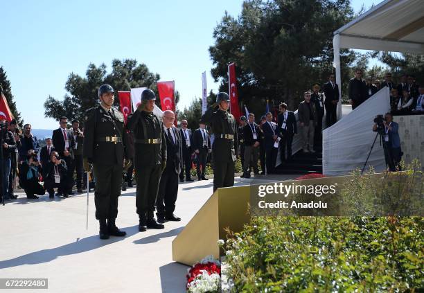 Turkish Culture and Tourism Minister Nabi Avci lays stands in silence near martyrs' cemetery during the ceremony marking the 102nd anniversary of the...