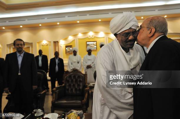Sudanese President Al Bashir greets Iranian Speaker of parliment, Ali Larijani, along with a high level delegation of Arab and Iranians, including...
