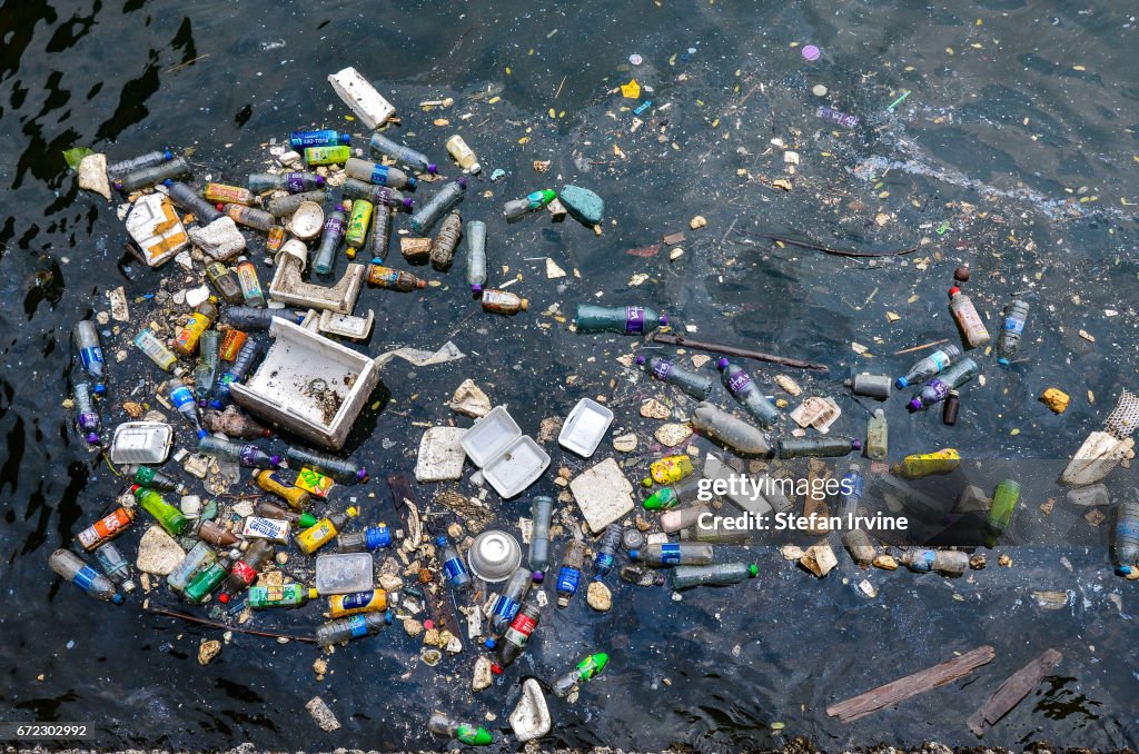 Floating plastic and styrofoam trash polluting a corner of...