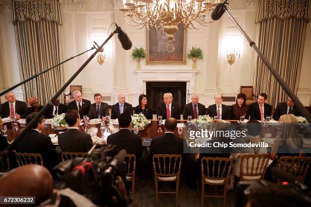 President Donald Trump delivers remarks while hosting ambassadors from the 15 country members of the United Nations Security Council flanked by his...
