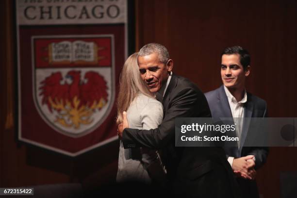 Former President Barack Obama greets youth leaders at the University of Chicago as he arrives for a forum to promote community organizing on April...