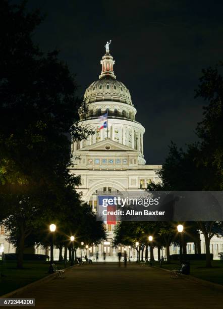 facade of the texas state capitol illuminated at night - austin nightlife stock pictures, royalty-free photos & images