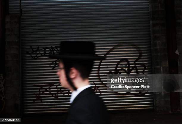 Hasidic teen walks through a Jewish Orthodox neighborhood in Brooklyn on April 24, 2017 in New York City. According to a new report released by the...