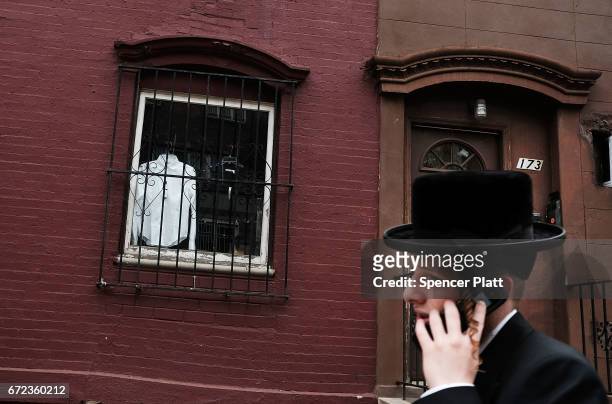 Hasidic teen walks through a Jewish Orthodox neighborhood in Brooklyn on April 24, 2017 in New York City. According to a new report released by the...